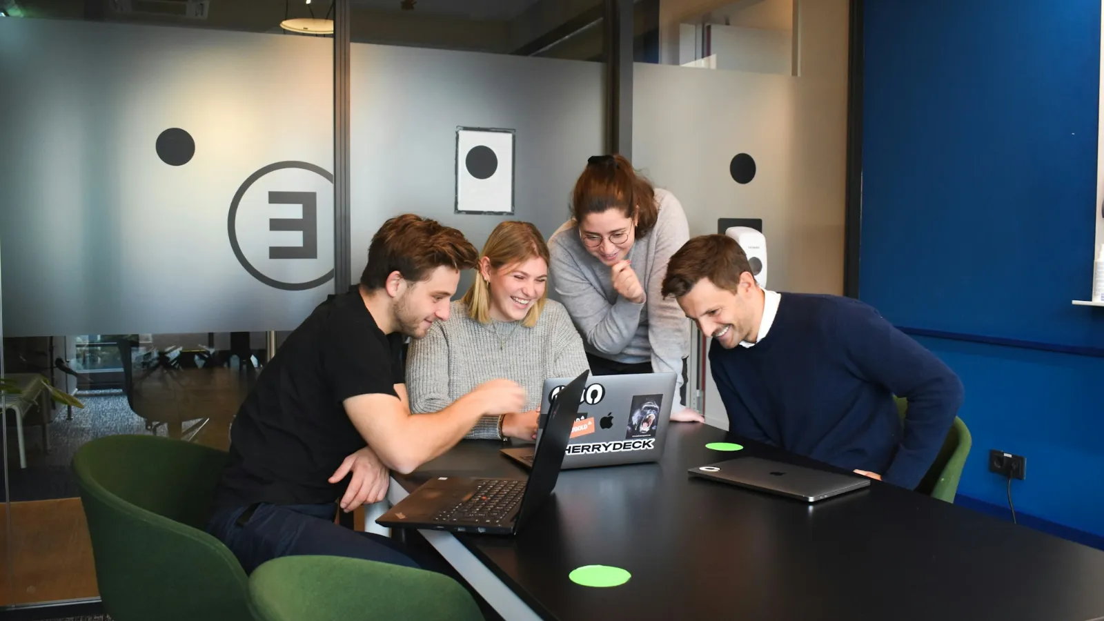 Team at laptops planning client portal features and requirements