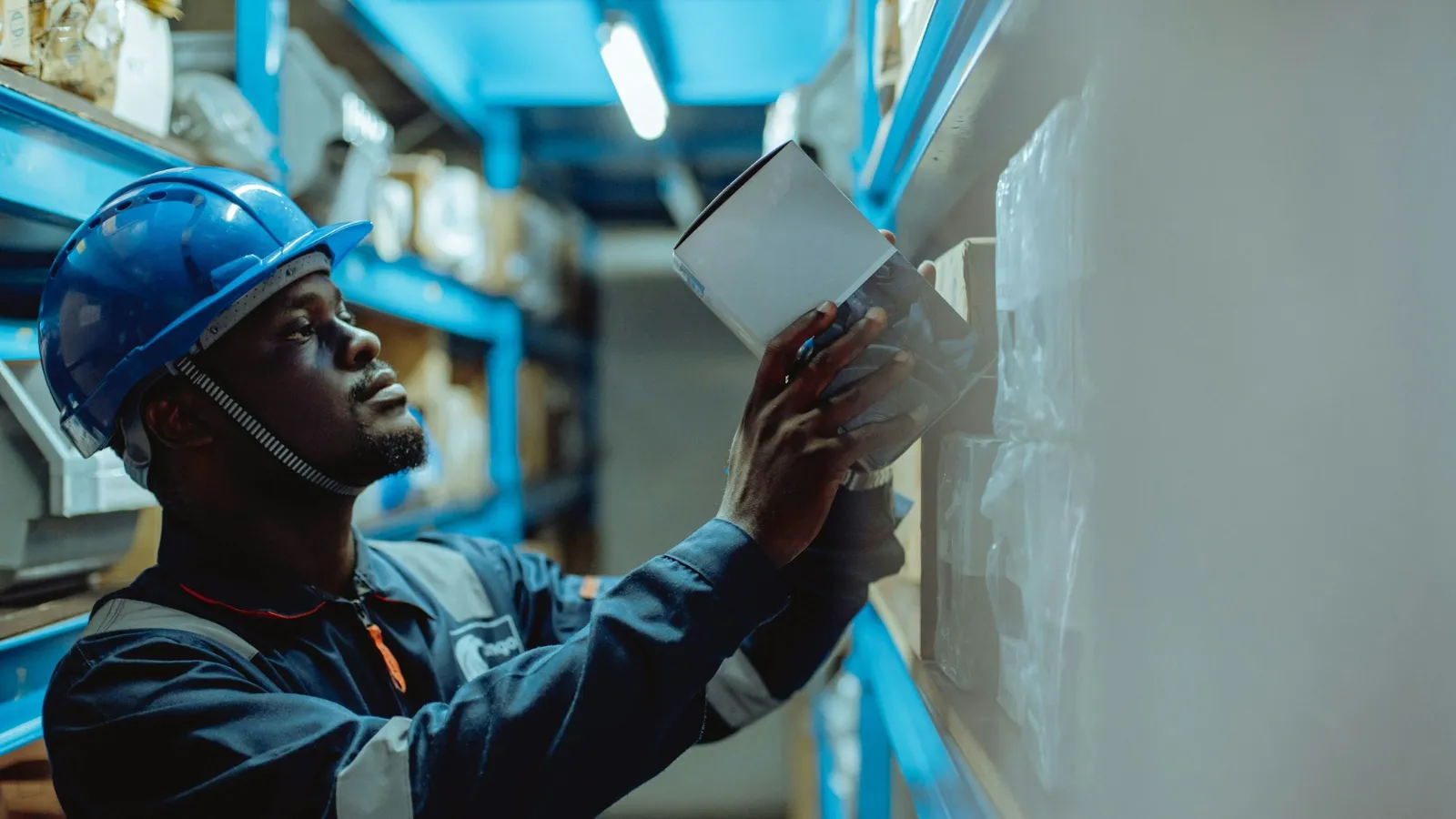 Warehouse manager checking stock paperwork for ERP and online store sync
