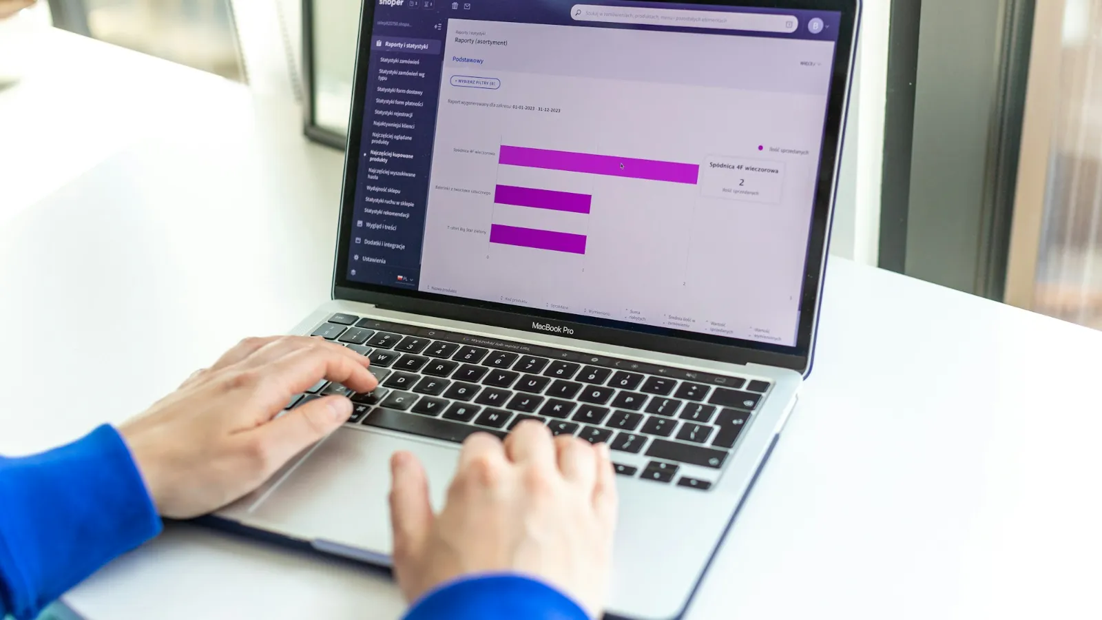 Store manager reviewing an online store dashboard on a laptop during a UX audit