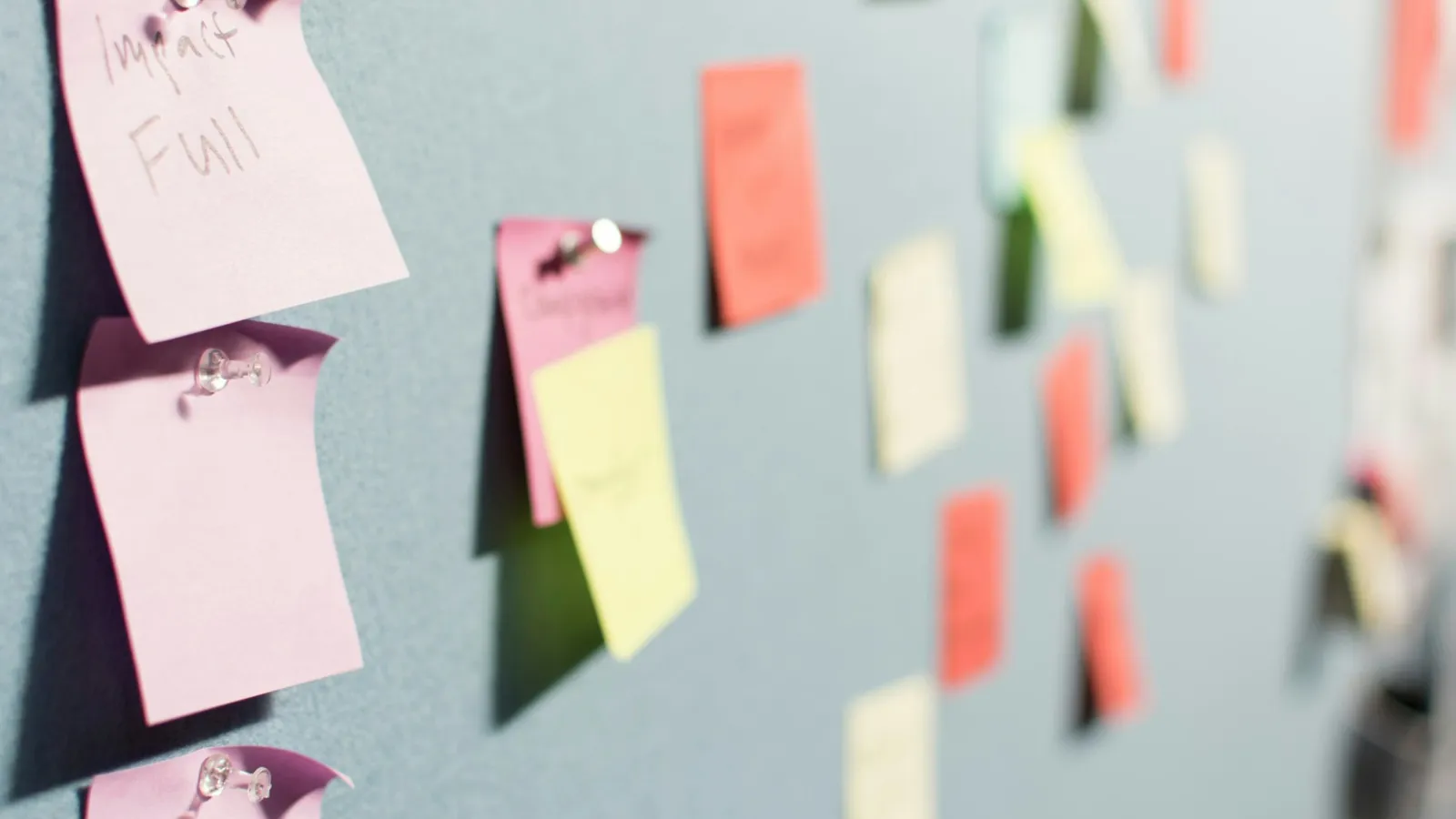 Colourful sticky notes on a board used to plan a website design brief