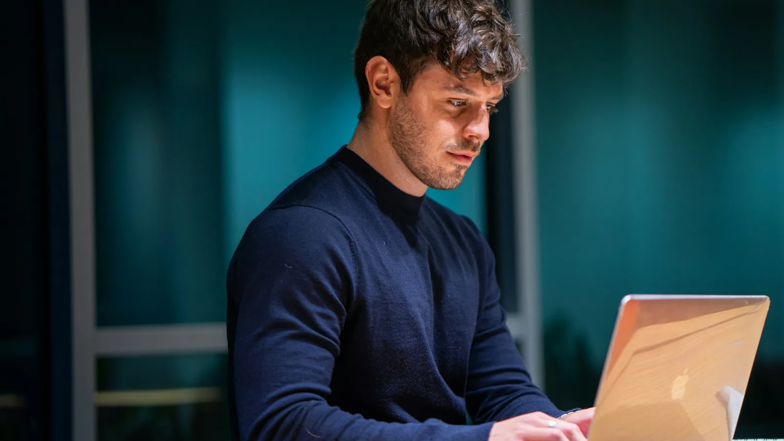 Business owner at a desk checking his company website on a laptop to see why it is not appearing in search